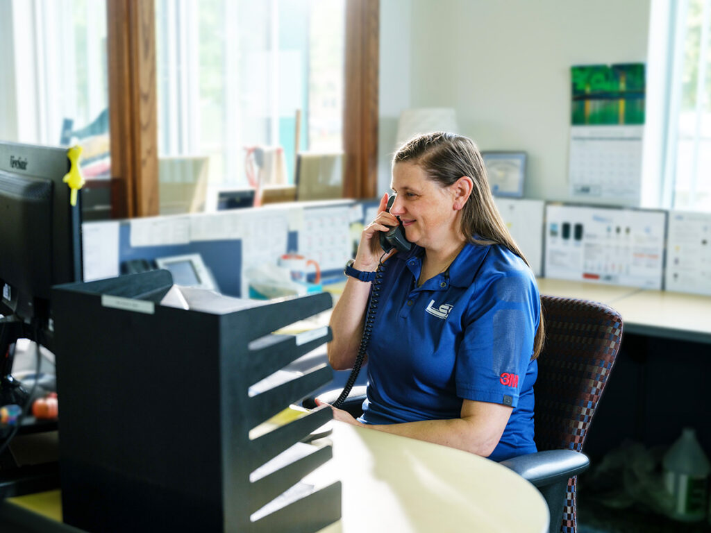 An LSS team member taking a customer call at the Lansing office